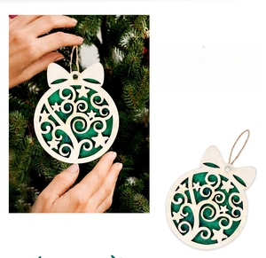 Detail of round wooden Christmas ornament with star cutout, bow tie and twine hanger