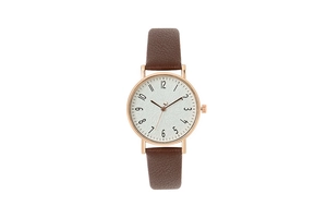 Detailed macro view of dark brown leather strap and rose gold bezel on a ladies watch