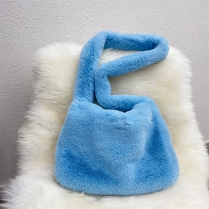 Macro detail of vibrant blue faux fur tote bag with soft fluffy texture and rich fibers