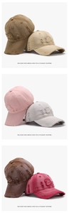 Close-up of vintage washed baseball caps with B patch and distressed ripped details in six colors