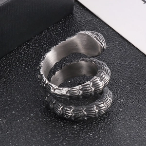 Detailed close-up of a vintage punk snake ring with intricate metal scale textures