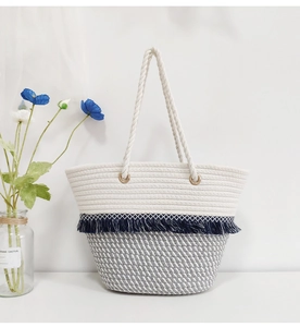Detail of bohemian cotton woven tote bag featuring blue fringe and textured patterns
