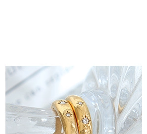 Close-up of thick 18K gold plated earrings featuring starset crystals and a chunky texture