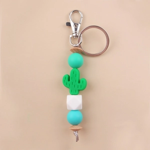 Detail of DIY cactus silicone bead keychain with mint green wood beads and metal ring