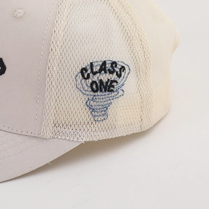 Detailed close-up of CLASS ONE embroidery on breathable mesh kids' baseball cap