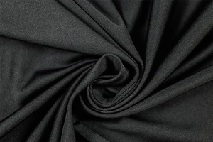 Detail of black knitted fabric with a silky texture and high-stretch mesh weave