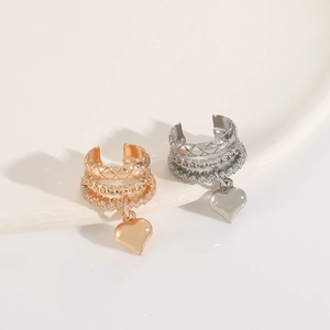 Detail of French vintage layered heart ear cuffs with crystals in gold and silver finish