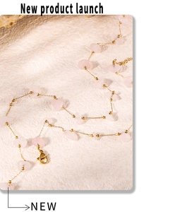 Detail of bohemian gold chain necklace featuring irregular pink natural stones and clasp