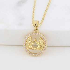 Macro detail of gold Gemini zodiac necklace pendant with sparkling zircon accents