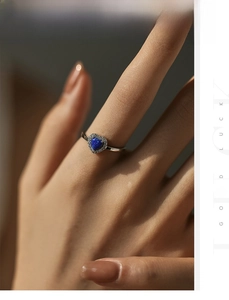 Macro shot of S925 silver ring featuring a blue heart opal center and pavé zircons