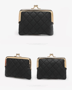 Detailed view of a black quilted PU leather coin purse with golden metal clasp closure