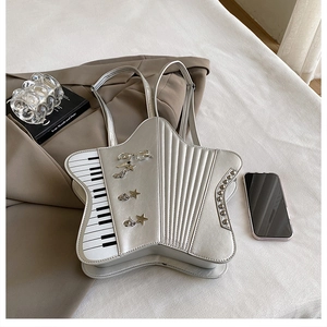 Detail of silver star-shaped backpack with piano keyboard pattern and metallic studs