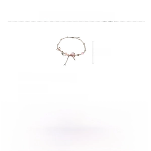 Detailed view of pink resin heart and bow necklace with glass beads and zircon accents