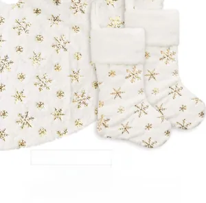 Macro detail of plush white Christmas stocking with shiny gold snowflake embroidery