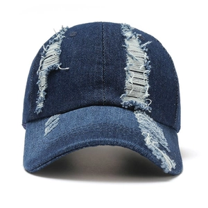 Distressed denim baseball cap with vintage frayed holes and classic sunshade brim