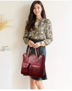Detailed view of large dark red PU leather tote bag with exterior zipper pockets