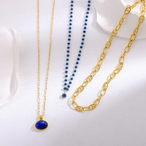 Three-piece vintage layered necklace set with blue gemstone pendant and gold chain
