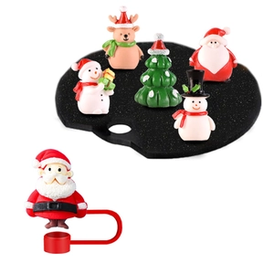 Detail of Christmas themed mini resin figurines with Santa, deer and tree for cup straw toppers