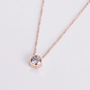 Close-up of hexagonal rose gold necklace featuring a brilliant round-cut zircon stone