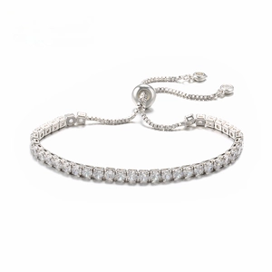 Macro detail of silver tennis bracelet featuring micro-pave zircons and slider clasp