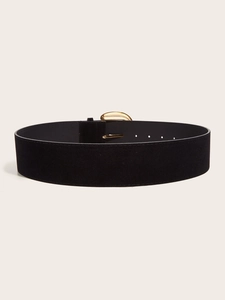 Detail of wide black suede belt with textured golden crescent buckle and holes