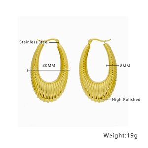 Detail of high polished gold stainless steel C-shape earrings with pleated texture
