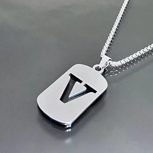 Close-up of a silver titanium steel necklace featuring a rectangular hollow letter V pendant