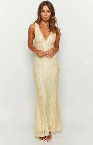 Macro shot of delicate yellow and white floral lace embroidery on a mesh dress