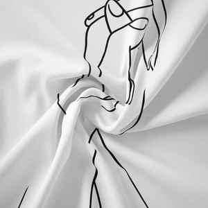 Detailed macro view of black line art printing on a soft white minimalist cotton tapestry