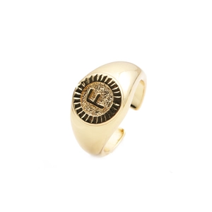 Detailed view of gold plated round signet ring with letter F and adjustable band