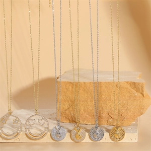 Gold and silver 14K gold-plated smiley face necklaces with zircon pendants on stone base