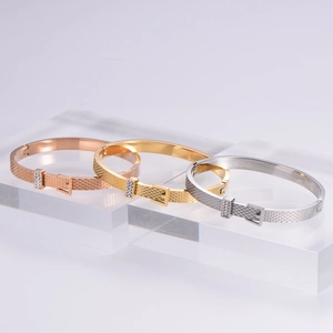 Detailed close-up of woven buckle bracelets in rose gold, gold, and silver finishes