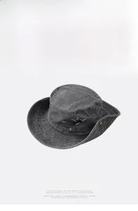 Detail view of washed dark gray cotton outdoor hat with star-shaped rhinestone patches