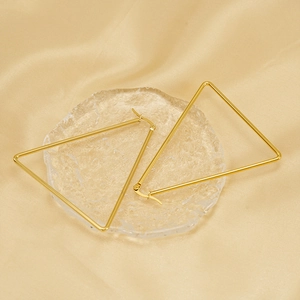 Minimalist geometric gold triangle earrings on silk fabric with polished steel texture