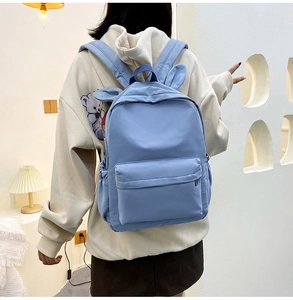 Blue nylon school backpack featuring cute rabbit ears decoration from a back view perspective