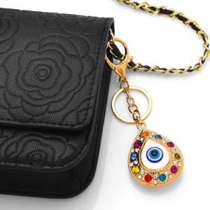Colorful rhinestone evil eye teardrop keychain hanging on a black embossed luxury bag