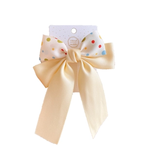 Polka dot double-layered bow hair clip with yellow satin ribbon and handmade label