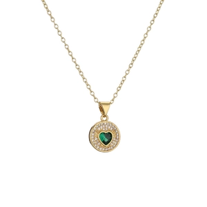 Gold necklace with green heart-shaped crystal pendant and zircon pavé detail on white base