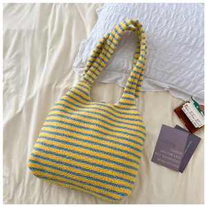 Detail of soft yellow and blue striped plush tote bag with cozy faux shearling texture