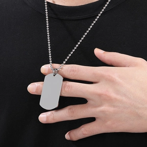 Polished silver stainless steel dog tag necklace with ball chain worn by male model