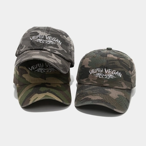 Close-up of camouflage baseball cap featuring white Very Vegan 3D embroidery detail