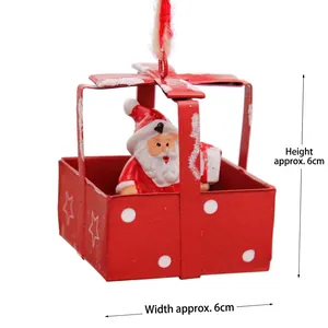 Detail of red Christmas gift box ornament with miniature Santa Claus inside, 6cm height