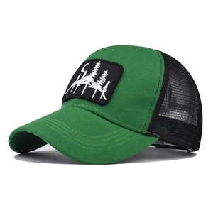 Detailed close-up of mountain and moon embroidery on the green trucker hat front panel
