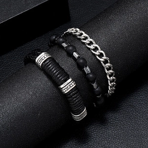 Detailed shot of three-piece set with black braided leather and LOVE engraved metal beads