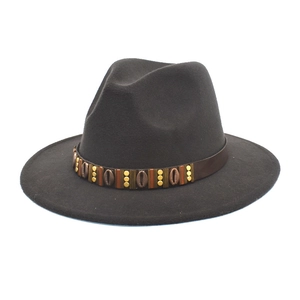 Detail of wool fedora hat featuring a brown leather band with brass metal beads