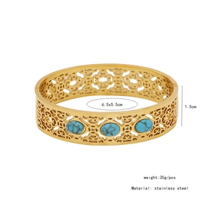 Detail of vintage hollow stainless steel cuff bracelet with three oval turquoise stones