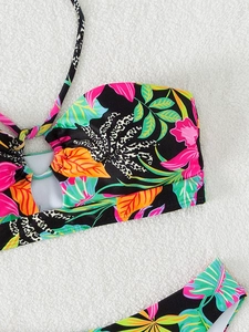 Detail of tropical floral and leopard print bikini top with metal ring on white fur
