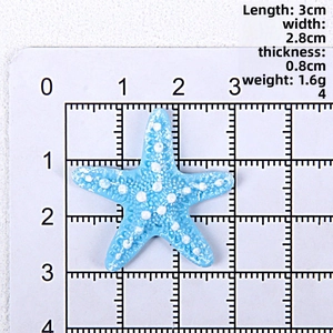 Macro view of blue resin starfish accessory showing 3cm dimensions on scale board