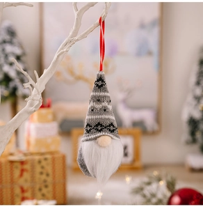 Christmas gnome ornament with grey knitted hat and white beard on festive background