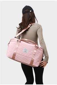 Pink quilted travel bag with large capacity shown in a back-view crossbody pose